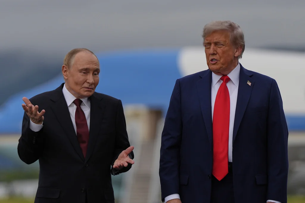 Putin taps ear and shrugs when asked whether he would stop ‘killing civilians’