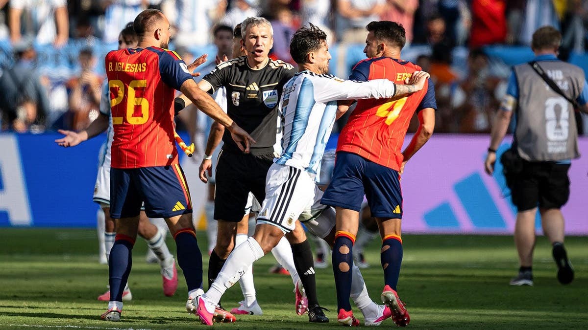 World Cup brawl sees Argentina player putting hand on throat of Spain opponent after match at george magazine